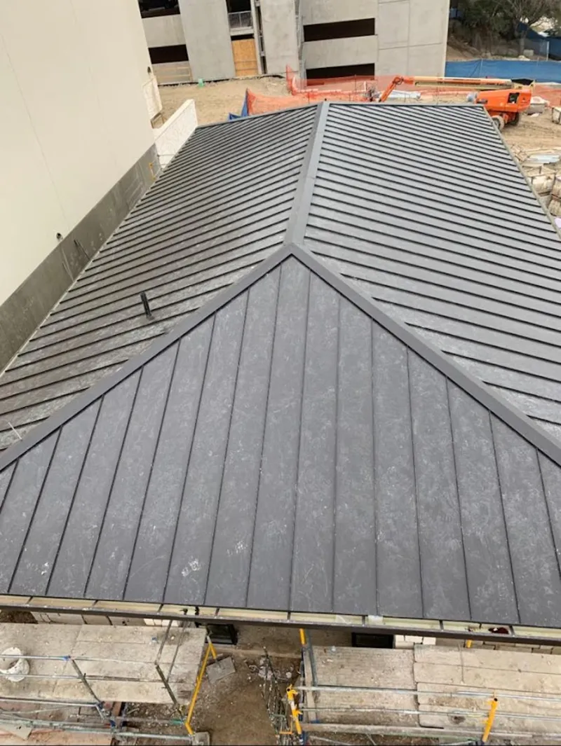Commercial metal roof construction with crane equipment in Grayslake