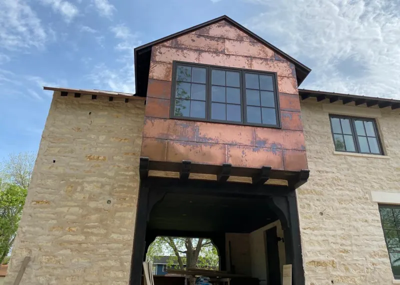 Copper metal panel facade on a stone building for Metal Roof Coating in Grayslake