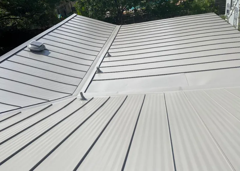 Solar attic fan installed on a metal roof for Roof Ventilation in Grayslake